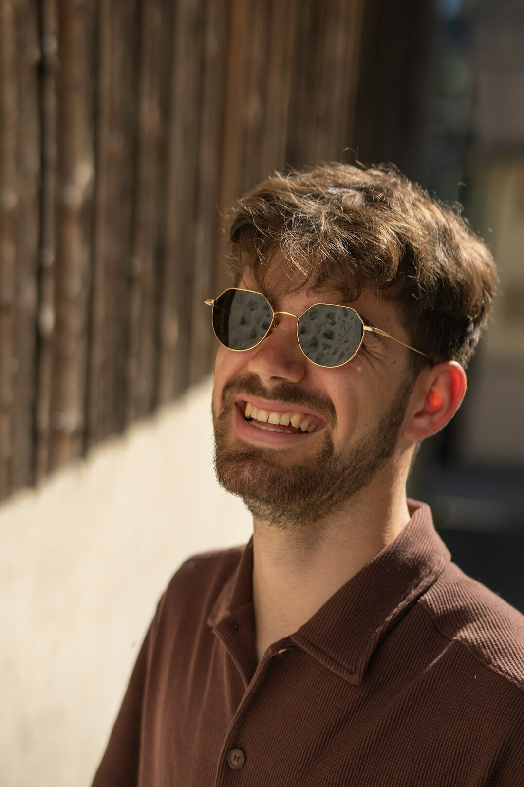 Portrait of a Belgian man in his thirties wearing glasses and a sweater