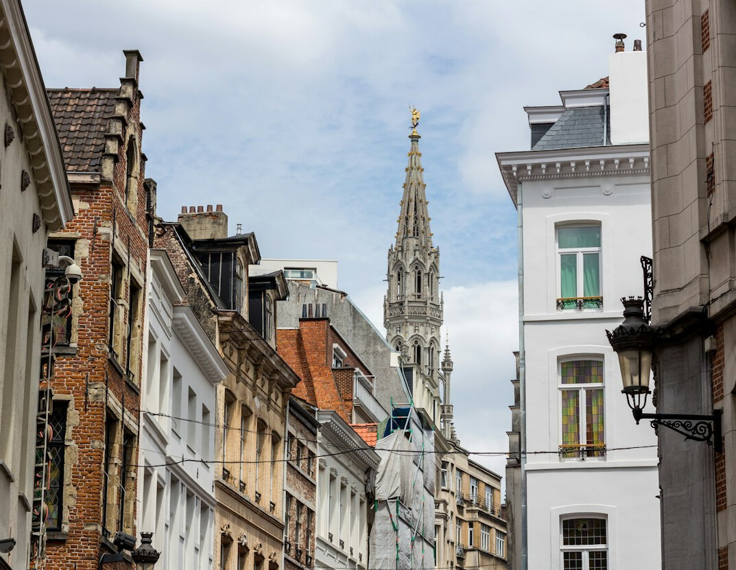 Daytime cityscape of Brussels mixing historic and modern buildings under a blue sky