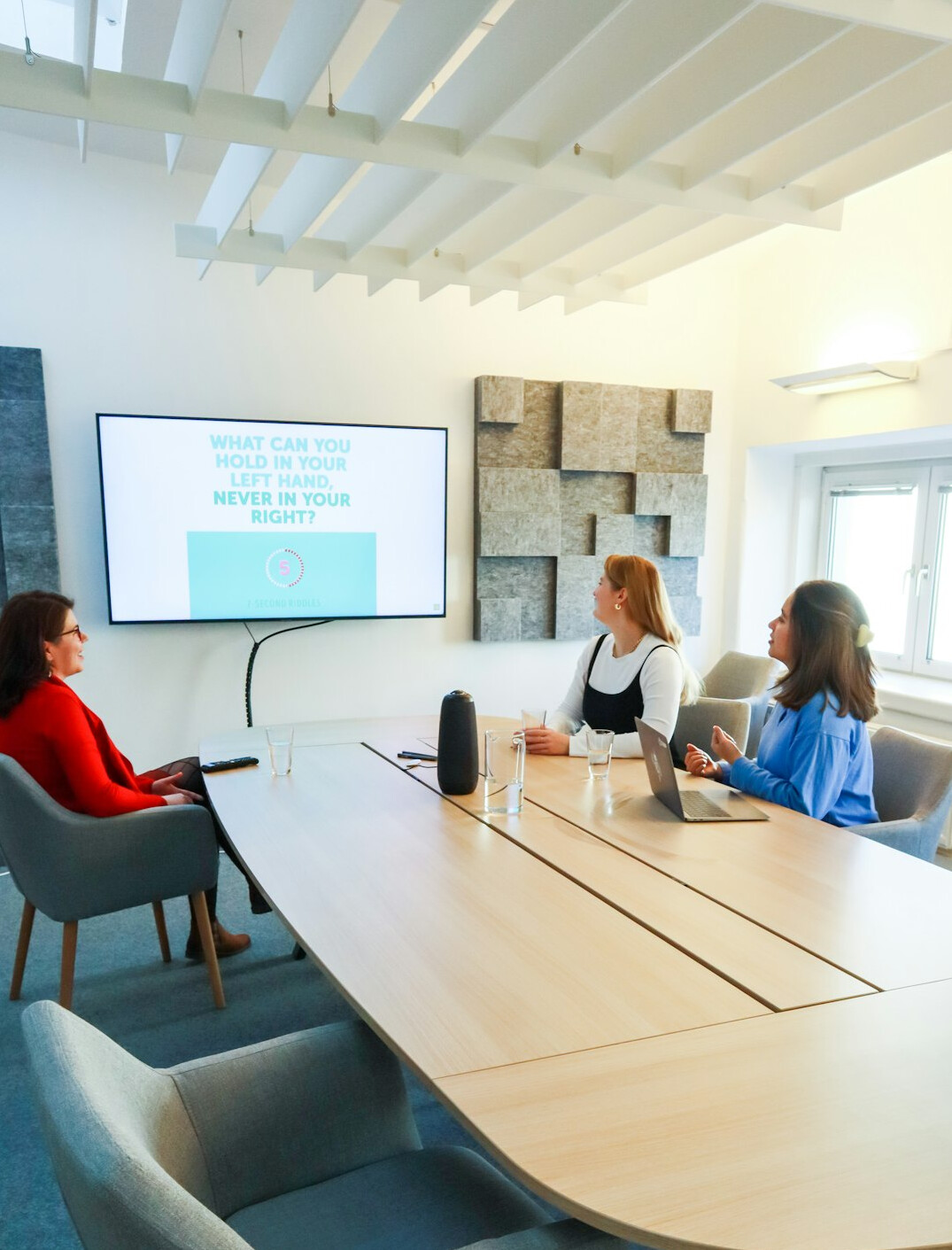 Empty modern meeting room with chairs arranged in a circle and large windows